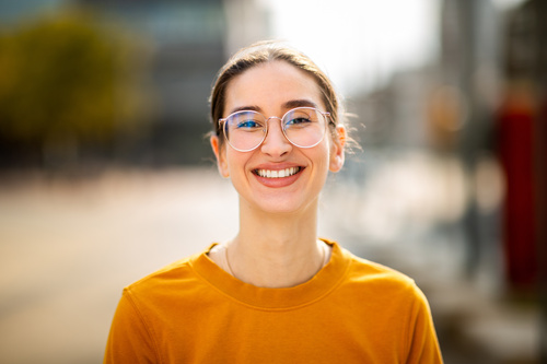 Portrait of attractive young caucasian woman smiling outside
